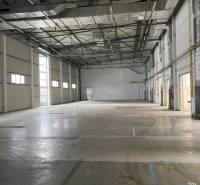 Empty interior of warehouses and halls with high ceilings and industrial lighting.