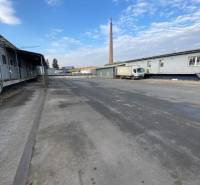The area on Bytčická Street in Žilina with warehouses and a chimney in the background.