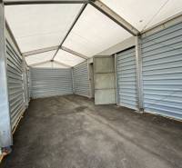 The interior of a storage hall with a steel structure and a white ceiling.