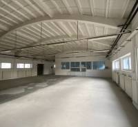 Spacious interior with large windows and an arched ceiling in Warehouses and Halls.