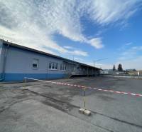 A space with warehouses and halls on Bytčická Street in Žilina, bordered by tape.