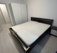 Bedroom with a double bed and a wardrobe in a 2-room apartment.