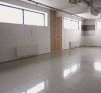 Spacious commercial premises with windows, tiling, and an HVAC system, suitable for rent.