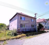 A family house in Hontianske Nemce with two floors, a sloped roof, close to the road.