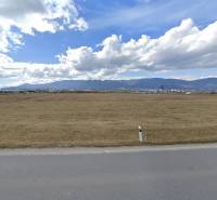Commercial land in Sučany, flat terrain, visible mountains in the distance, suitable for construction.