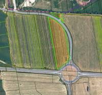 Aerial view of divided agricultural land in Sučany near the roundabout.