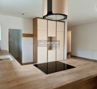 A kitchen unit with wooden countertops and light cabinets in a family house.