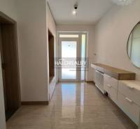 A hallway with a mirror and storage space in a family house.