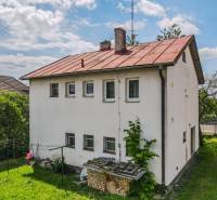 A family house in Pruské with a grassy garden and a simple architectural style.