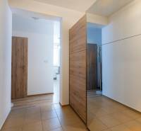 Interior of a 2-room apartment with tiles and wooden elements in the hallways.