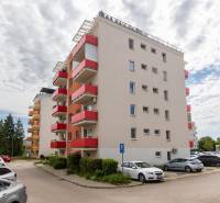 Apartment building on Potravinárska Street in Nitra with an adjacent parking lot.