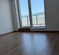 A room with a wooden floor and a large window, 2-room apartment.
