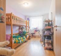 A bright hallway in a 3-room apartment with wooden flooring, a bench, and a wardrobe.