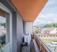 Parking in front of the apartment building in Poprad, 3-room apartments with balconies and a garage.