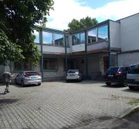 A courtyard with parked cars at the manufacturing premises on Beckovská Street in Bratislava - Ružinov.