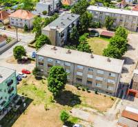 Aerial view of residential buildings and surroundings in Gabčíkovo with 2-room apartments.