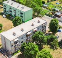 Aerial view of apartment buildings and greenery in Gabčíkovo, suitable for a 2-room apartment.