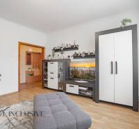 Living room in a two-room apartment with white furniture and decorations.