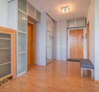 Entrance hall in a 3-room apartment with wooden furniture and a built-in wardrobe.