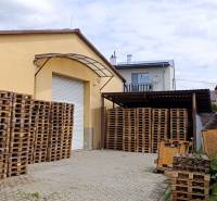 Warehouses and halls in Ilava on Kpt. Nálepku Street with pallets stored in the yard.