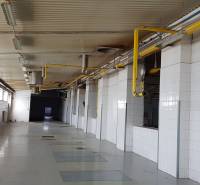 Interior of an industrial space with yellow pipes and white walls in warehouses and halls.
