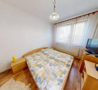Bedroom in a 3-room apartment with stylish furnishings, bed, and TV.