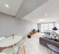 Living room with a dining table in a 2-room apartment, neutral colors, modern lighting.