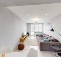 Living room with a sofa, table, and decorations in a 2-room apartment.
