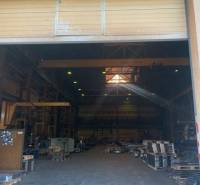 Interior of warehouses and halls with high ceilings, pallets, and lighting.