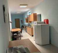 Offices with a kitchenette, tables, and chairs, suitable for breaks and refreshments.