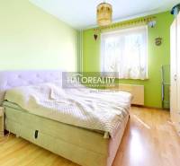 A bright bedroom with a bed, wardrobes, and wooden flooring in a 3-room apartment.