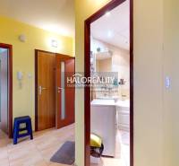 A hallway in a 3-room apartment with doors to the bathroom, kitchen, and living room.