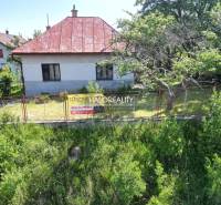 A family house in Vrbov, surrounded by trees and a fence, offered for sale.