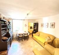 A living room in a cottage with comfortable yellow sofas and wooden furniture.