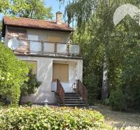 A cottage in Radvaň nad Dunajom, surrounded by greenery with a terrace and satellite.