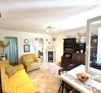 Living area with a sofa and dining table, a cottage with comfortable and functional furnishings.