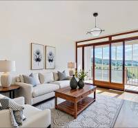 A bright living room in a 4-room apartment with a comfortable sofa and a balcony with a view.