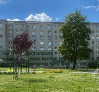 An apartment building on Okružná Street in Stará Ľubovňa surrounded by greenery and a playground.