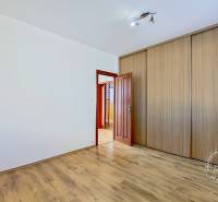 A room with a wooden floor and a built-in wardrobe in a 4-room apartment.