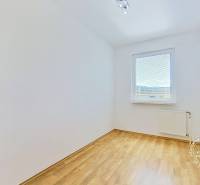 A bright room with laminate flooring and a window, ideal for a 4-room apartment.