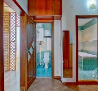 Interior of a 4-room apartment with wooden doors, a bathroom, and a toilet.