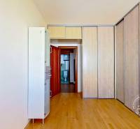 A room in a 4-room apartment with a large built-in wardrobe and a view of the bathroom.