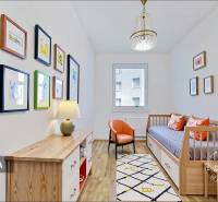Children's room in a 4-room apartment with a sofa, armchair, and wall decorations.