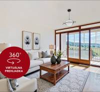 Living room in a 4-room apartment with a sofa, coffee table, and a view of the landscape.
