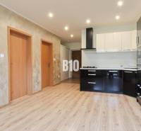 Interior of a 3-room apartment with a bright kitchen and wooden flooring.