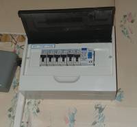 A fuse box in a 2-room apartment, located on the wall near the ceiling.