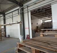 Warehouse and hall space with wooden pallets and entrance to another room.