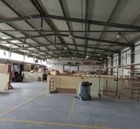 Spacious interior of warehouses and halls with shelves, equipment, and a material cart.