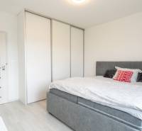 Bedroom in a 3-room apartment with a bed, wardrobe, and light-colored door.