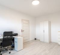 A workspace in a 3-room apartment with a desk, a wardrobe, and a chest of drawers.